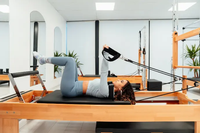 a woman is doing a plank exercise in a gym